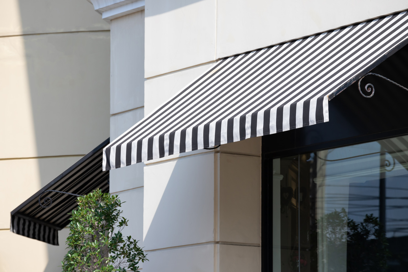 Black and white striped awning over a storefront entrance